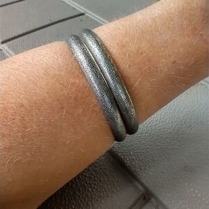 Set of 2 silvertone bangle bracelets.